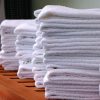 Stacks of gym towels on wood bench